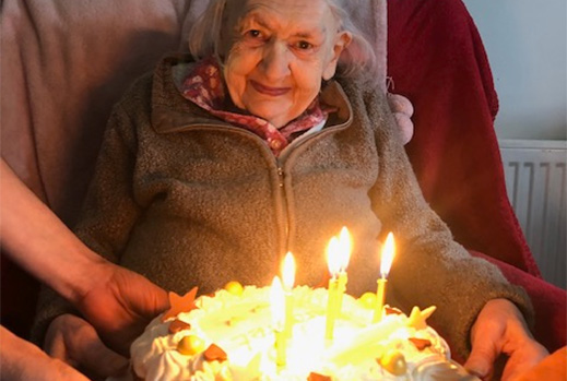 Mrs Margaret Griffiths holding her birthday cake with candles