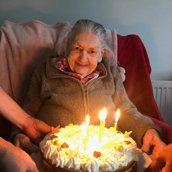 Mrs Margaret Griffiths holding her birthday cake with candles